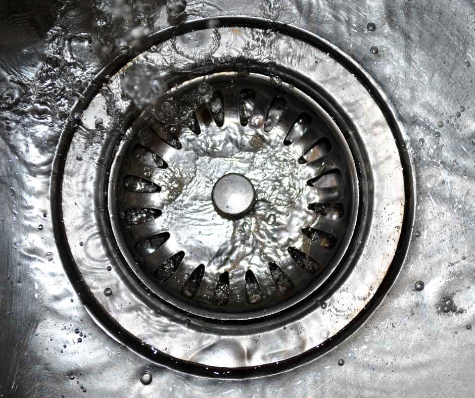 A sink drain with water flowing
