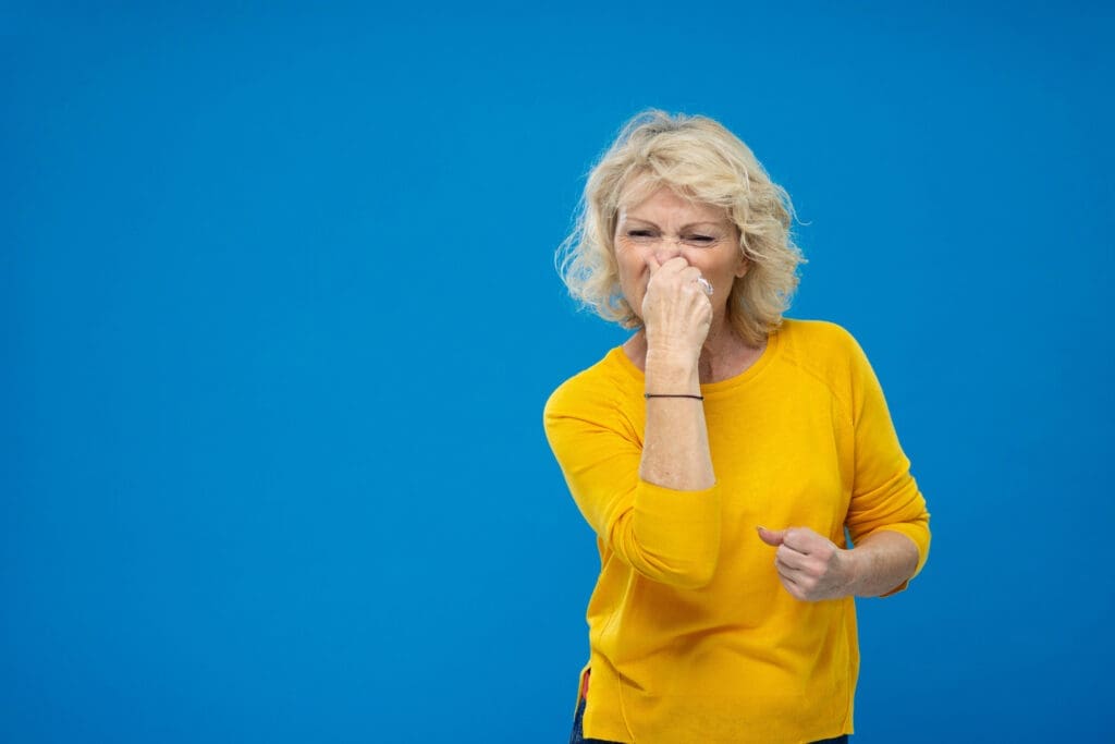 Senior Woman Plugging Her Nose