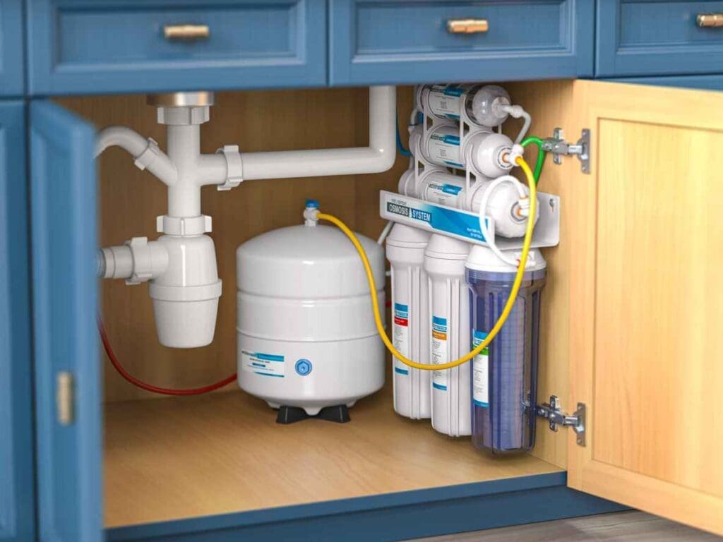 Reverse osmosis water filtration system under sink in a kitchen.