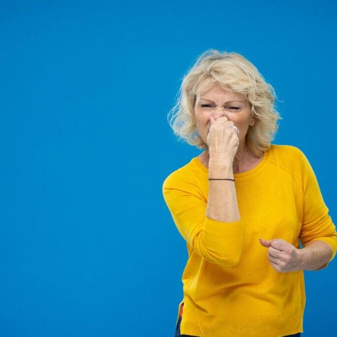 Senior Woman Plugging Her Nose